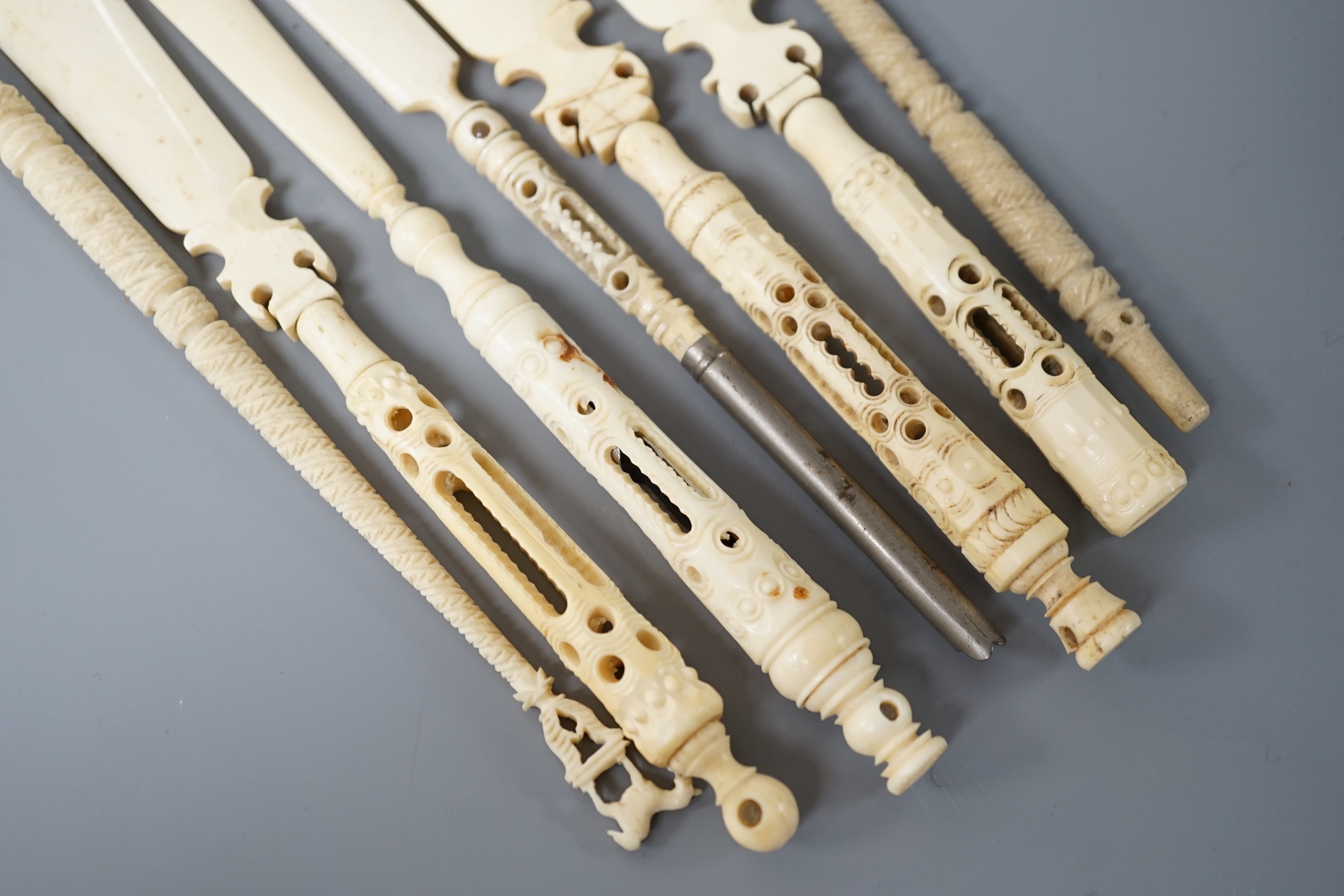 Four Victorian bone Stanhope paper knives, and three other bone items